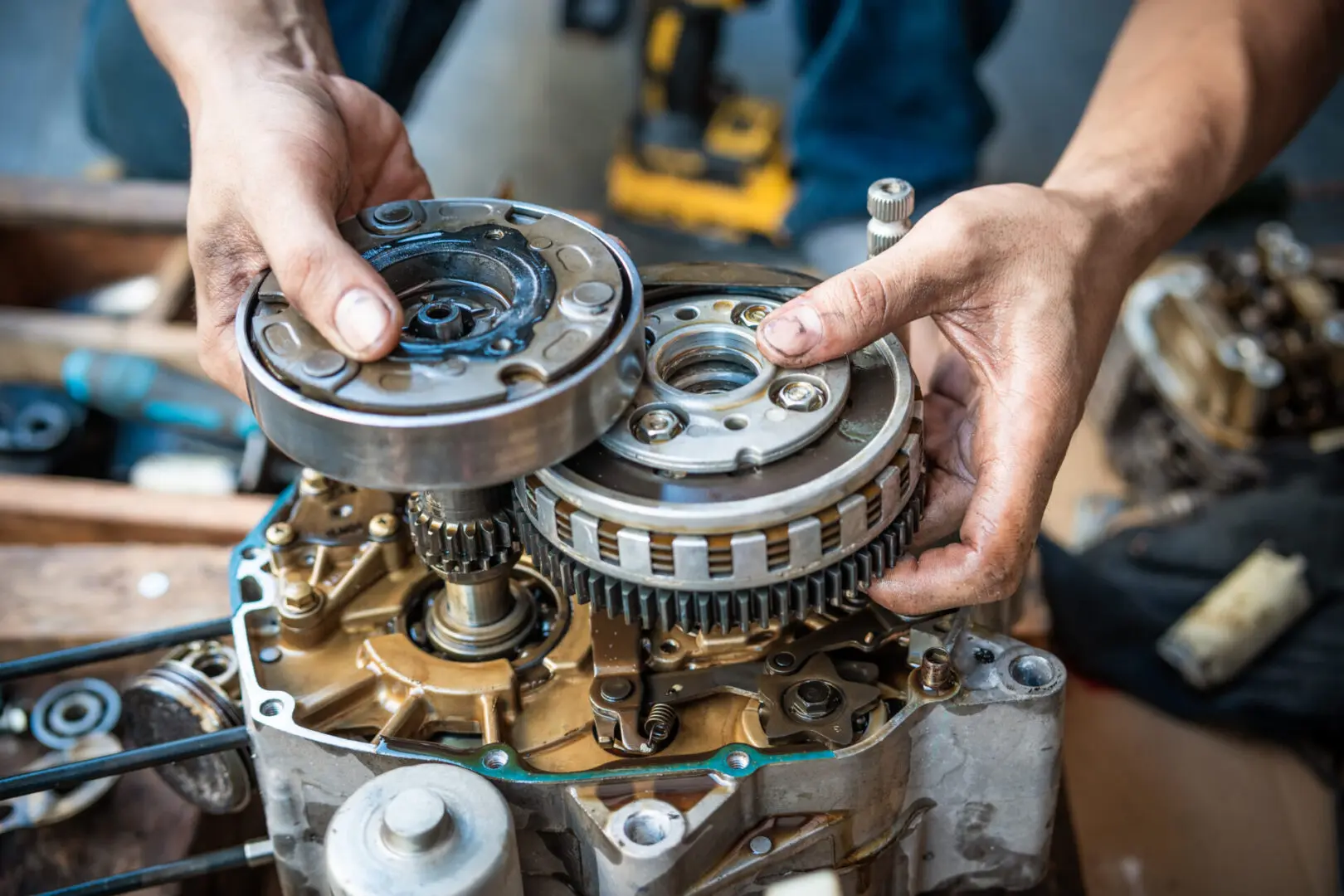 Hands assembling mechanical engine components.